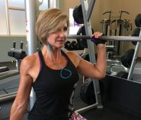 Woman strength trains in the gym with weights West Financial Services