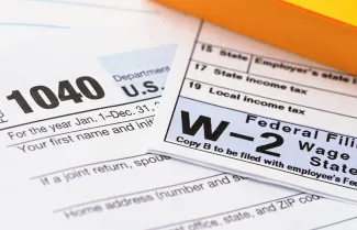 An image of IRS forms 1040 and W-2. West Financial Services.