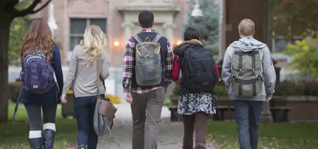 Students walking towards a college building. West Financial Services